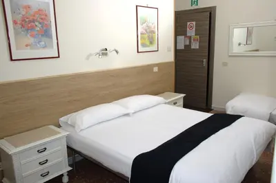 a hotel room with two beds and a sink at In vacanza da Sara in Rome