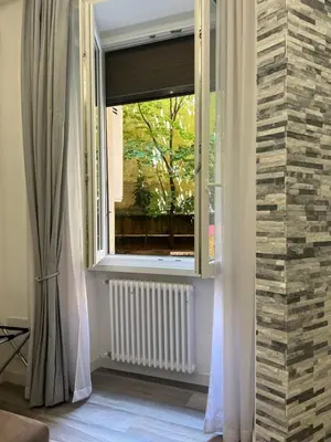 a room with a window and a radiator at ARTPA Rome Apartments in Rome