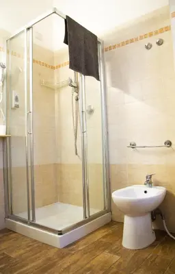 a bathroom with a shower with a toilet and a sink at Marco E Laura Affittacamere al Vaticano in Rome