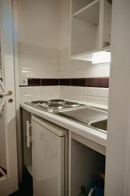 a kitchen with a stove and a sink at Cozy Studio Parlamento in Rome