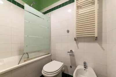 a bathroom with a toilet and a sink and a tub at Vatican Corner Family Apartment in Rome