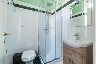 a bathroom with a shower and a toilet and a sink at Vatican Corner Family Apartment in Rome