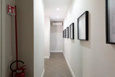 a hallway with a row of pictures on the wall at Dream Holiday Home in Rome
