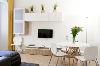 a living room with a table and chairs and a tv at Miani House in Rome