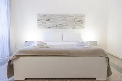 a white bedroom with a white bed in a room at Miani House in Rome