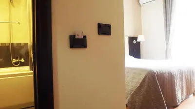 a bedroom with a bed and two pictures on the wall at Hotel Nautilus in Rome