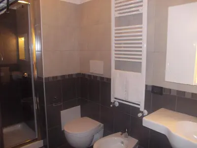 a small bathroom with a toilet and a sink at Hotel Nautilus in Rome