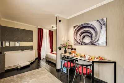a room with a table and chairs and a bathroom at PAX hotel in Rome