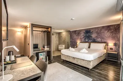 a hotel room with a bed and a desk at PAX hotel in Rome