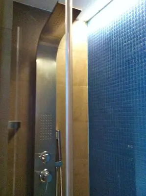 a shower with a glass door in a bathroom at WellnessINNrome shortlet in Rome