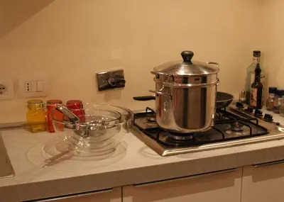 a pot on top of a stove in a kitchen at WellnessINNrome shortlet in Rome