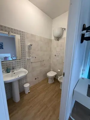 a bathroom with a sink and a toilet at Juna's guest house in Rome
