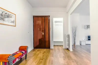 a living room with a wooden door and a couch at Apartment Costanza in Rome in Rome