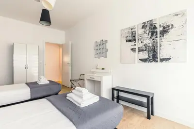 a bedroom with two beds and a table and a picture at Apartment Costanza in Rome in Rome