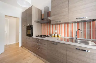 a large kitchen with wooden cabinets and a sink at Apartment Costanza in Rome in Rome