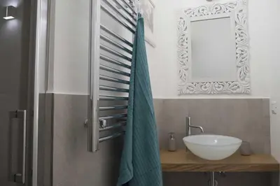 a bathroom with a sink and a mirror at Tempo Lento in Rome