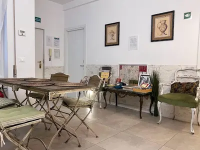 a room with tables and chairs and a table with a desk at Tempo Lento in Rome