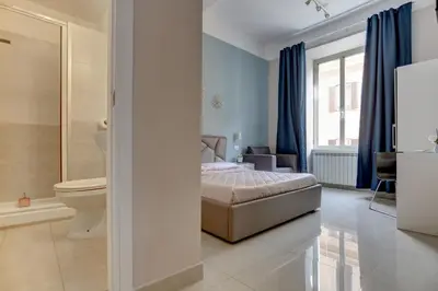 a bedroom with a bed and a bathroom at Claudia House Roma Termini in Rome