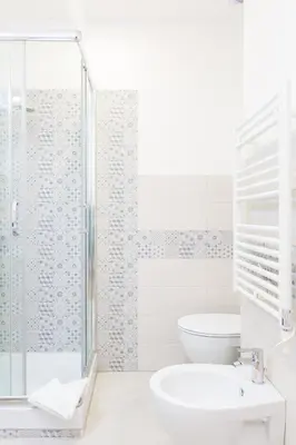 a bathroom with a shower and a toilet and a sink at The Regal Suite in Rome