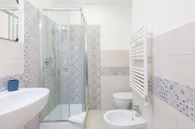 a bathroom with a shower and a sink and a toilet at The Regal Suite in Rome