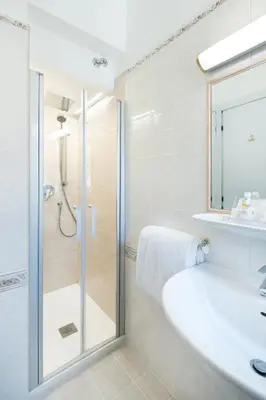 a bathroom with a shower and a sink at Hotel Santa Prisca in Rome