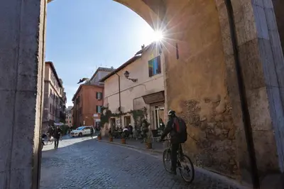 a man riding a bike down a street at Enchanting loft in Trastevere in Rome