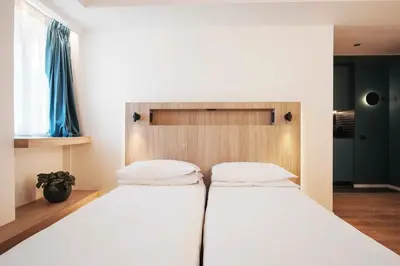 a bedroom with two beds and a headboard at Aparthotel Colombo Roma in Rome
