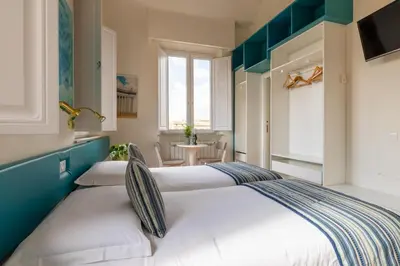 a bedroom with two beds and a table at Superior Relais FCollection Temple View in Rome