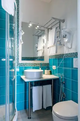 a blue bathroom with a sink and a toilet at Superior Relais FCollection Temple View in Rome