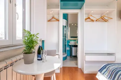 a room with a white table and a bedroom at Superior Relais FCollection Temple View in Rome