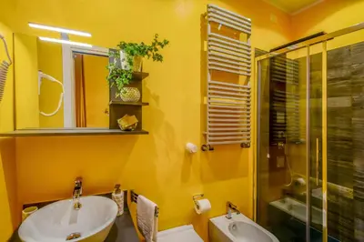an orange bathroom with a toilet and a sink at Allegra's House Caracciolo in Rome
