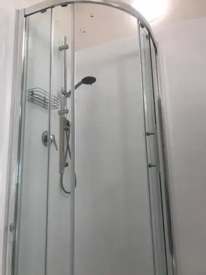 a shower with a glass door in a bathroom at Habana's Design in Rome