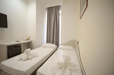 a hospital room with two beds and a tv at Romerooms in Rome