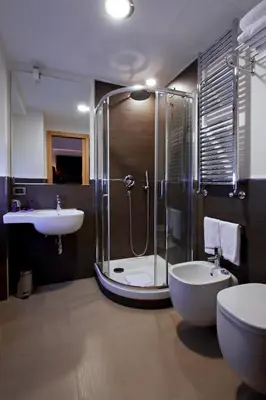 a bathroom with a shower and a sink and a toilet at Hotel Gravina San Pietro in Rome