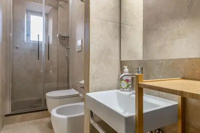 a bathroom with a sink and a toilet and a shower at Principe Guesthouse in Rome