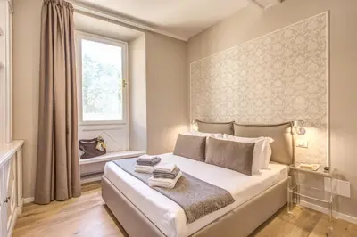 a bedroom with a large bed and a window at The Spanish Suite Via di Ripetta in Rome