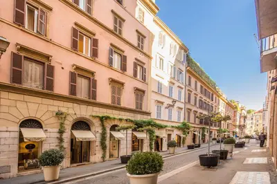 an empty street in a city with buildings at The Spanish Suite Via di Ripetta in Rome