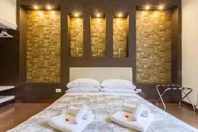 a bedroom with a bed with white towels on it at Stazione San Pietro 20 Apartment in Rome