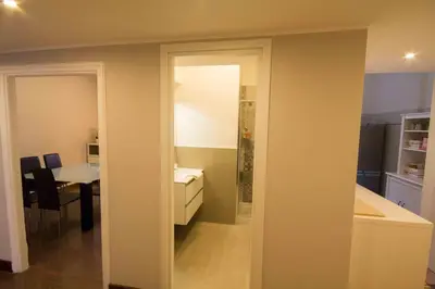 a room with a kitchen and a dining room at Stazione San Pietro 20 Apartment in Rome