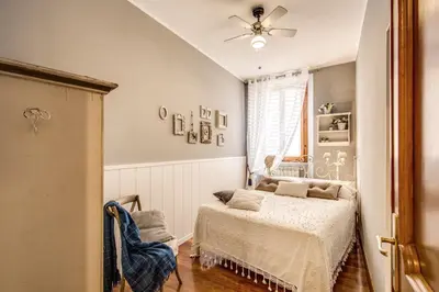 a bedroom with a bed and a ceiling fan at Spanish Steps Miracle Suite in Rome