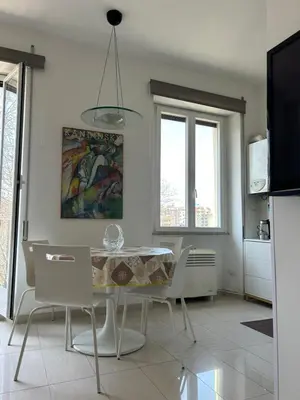 a kitchen and dining room with a table and chairs at La Riva Sinistra in Rome