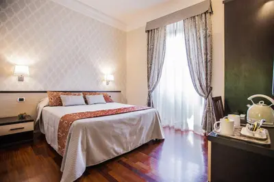 a bedroom with a bed and a large window at Domus Palatina in Rome