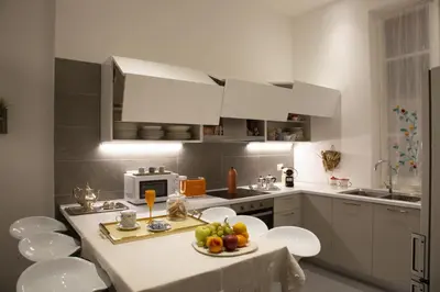 a kitchen with a table with fruit on it at Colosseum View Exclusive Apartment in Rome