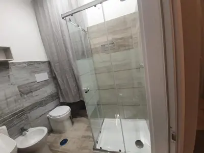 a bathroom with a glass shower and a toilet at My Rhome Prati in Rome
