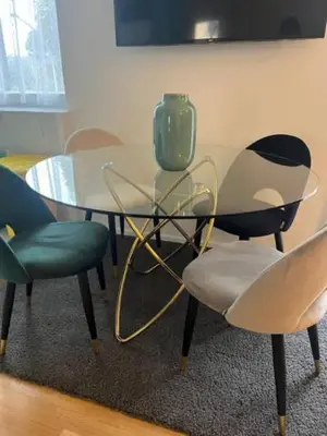 a glass table with chairs and a green vase on it at Duke's Apartment in Rome