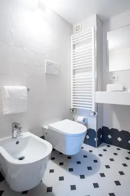 a white bathroom with a toilet and a sink at PgrHome Domus Pantheon in Rome
