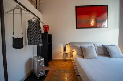 a bedroom with a bed and a dress hanging on the wall at PgrHome Domus Pantheon in Rome