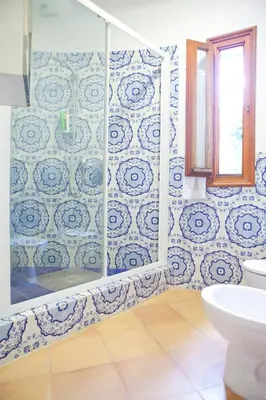 a bathroom with a shower with a toilet and a window at Relais La Canfora in Rome