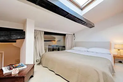 a bedroom with a large bed and a window at Trastevere Charming Loft | Romeloft in Rome