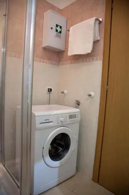 a washer and dryer in a small bathroom at Accogliente Appartamento al Colosseo in Rome